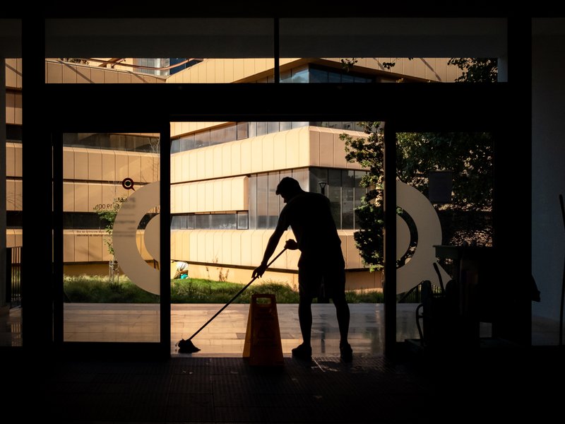 silhouette of person mopping